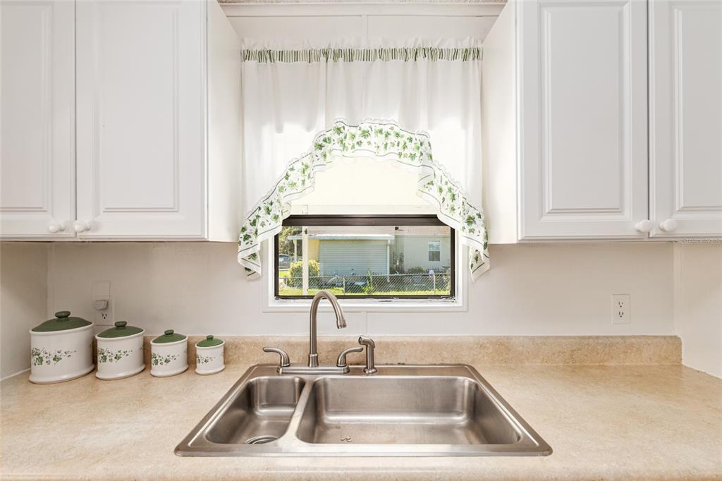 10085 Southeast 126th Place Belleview, FL 34420 - Photo 18 of 45 a kitchen with a sink and cabinets