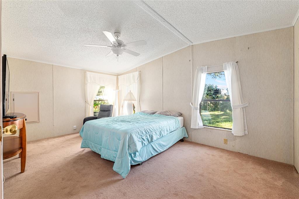 10085 Southeast 126th Place Belleview, FL 34420 - Photo 22 of 45 a living room with a bed furniture and a window