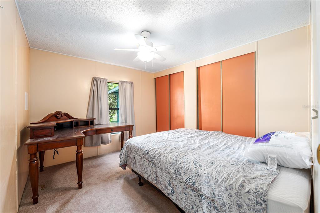 10085 Southeast 126th Place Belleview, FL 34420 - Photo 27 of 45 a bedroom with a bed and a window