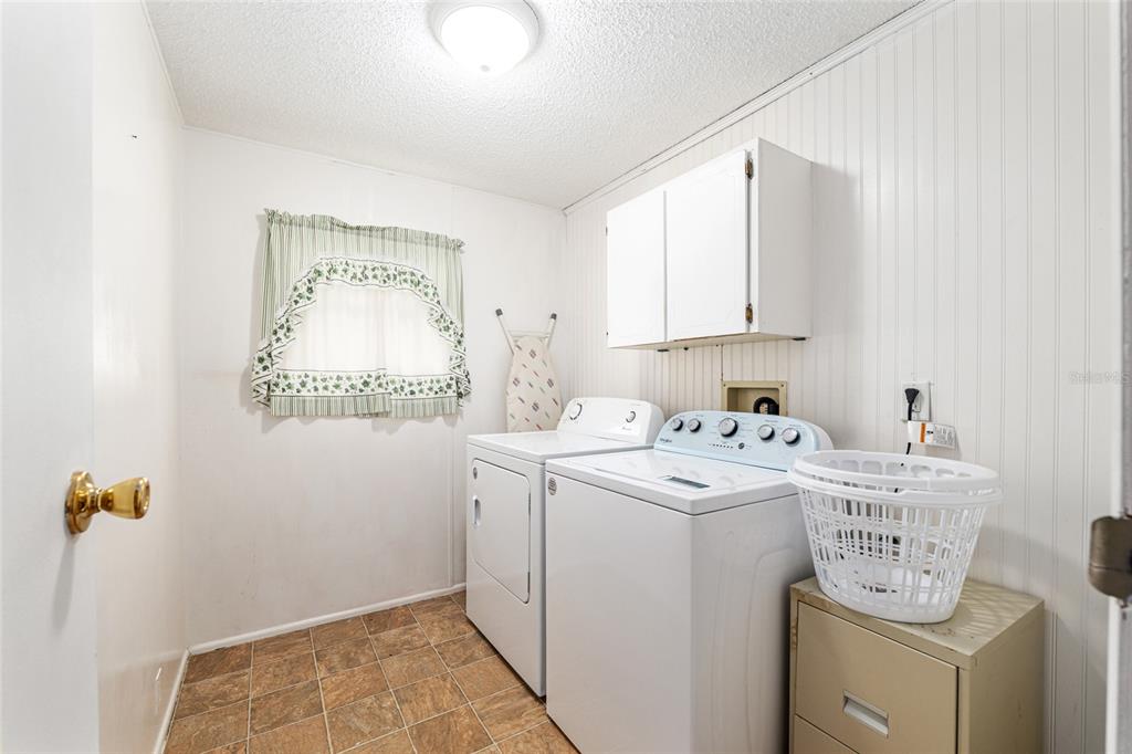 10085 Southeast 126th Place Belleview, FL 34420 - Photo 29 of 45 a utility room with a sink a cabinetry and a window