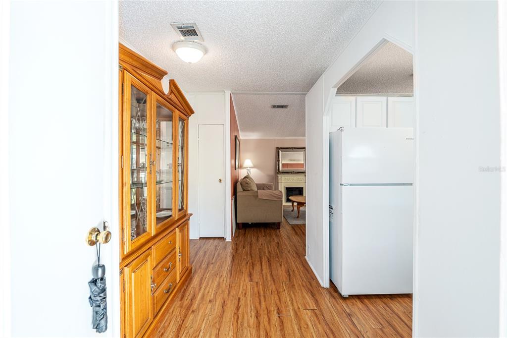 10085 Southeast 126th Place Belleview, FL 34420 - Photo 4 of 45 a view of a living room with a bed and wooden floor
