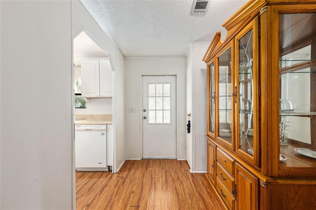 10085 Southeast 126th Place Belleview, FL 34420 - Photo 5 of 45 a view of a hallway with wooden floor and cabinet