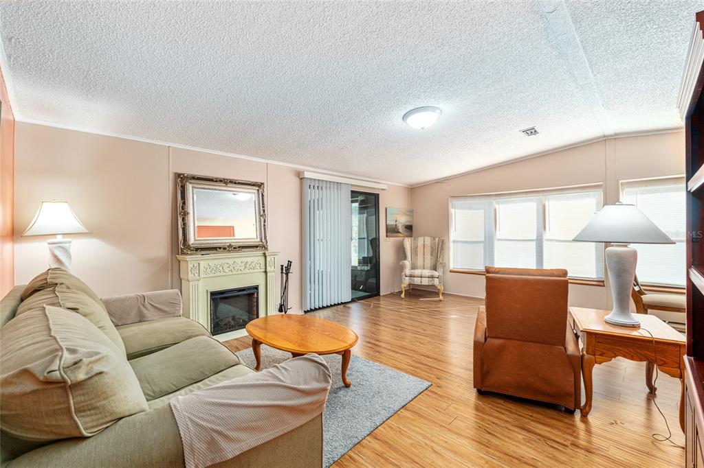 10085 Southeast 126th Place Belleview, FL 34420 - Photo 6 of 45 a living room with furniture and a fireplace