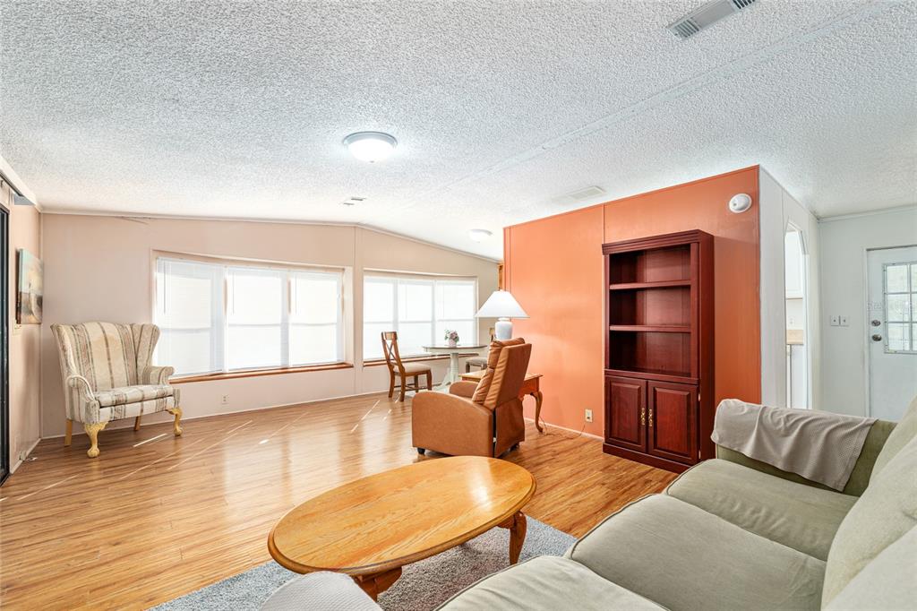 10085 Southeast 126th Place Belleview, FL 34420 - Photo 8 of 45 a living room with furniture and a large window