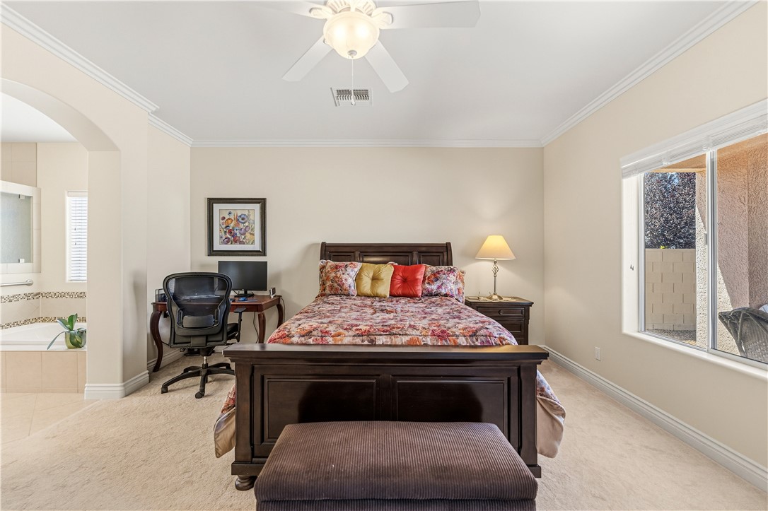 3315 Rainbow Mine Road Kingman, AZ 86401 - Photo 20 of 54 Bedroom featuring carpeted flooring, a ceiling fan, and a window with a view of greenery