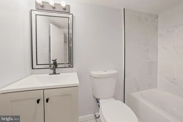 a bathroom with a toilet a sink and bathtub