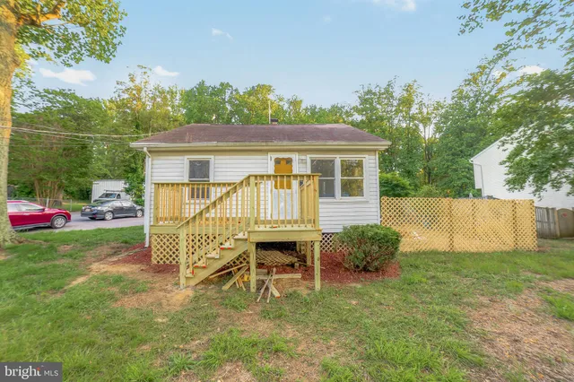 a view of a house with a yard and sitting area