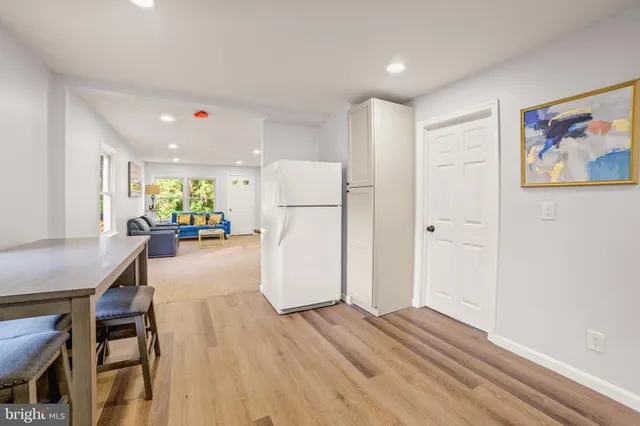 a kitchen with a refrigerator and a table