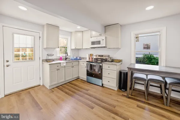 a kitchen that has a lot of cabinets in it and appliances