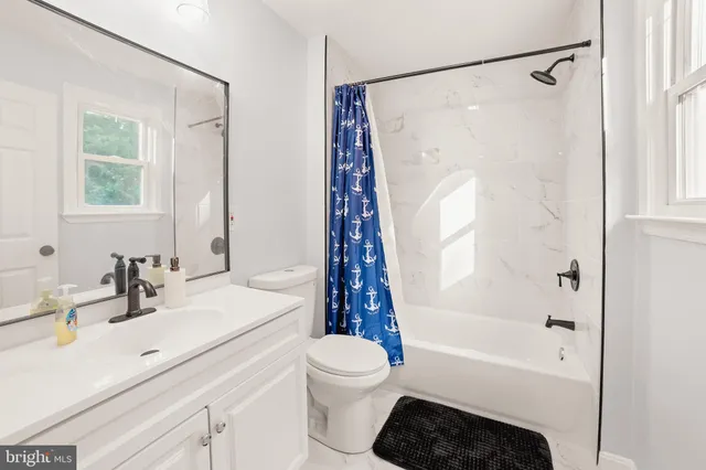 a bathroom with a sink a toilet and a bathtub
