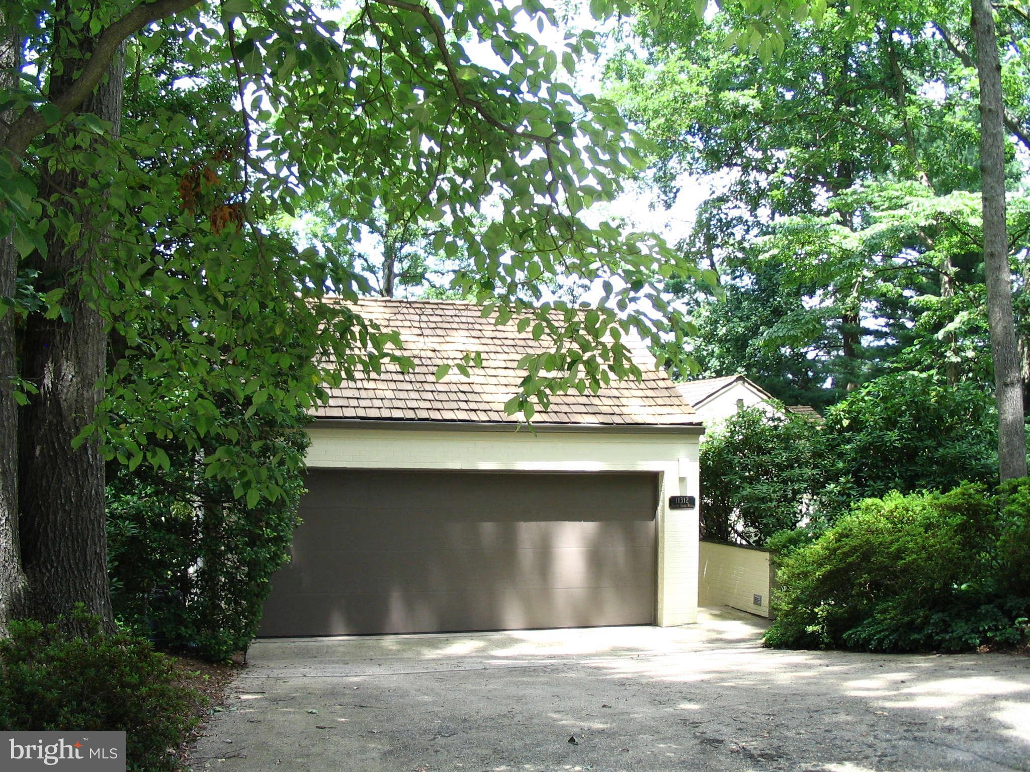 11312 South Shore Road Reston, VA 20190 - Photo 2 of 30 a front view of a house with a garage