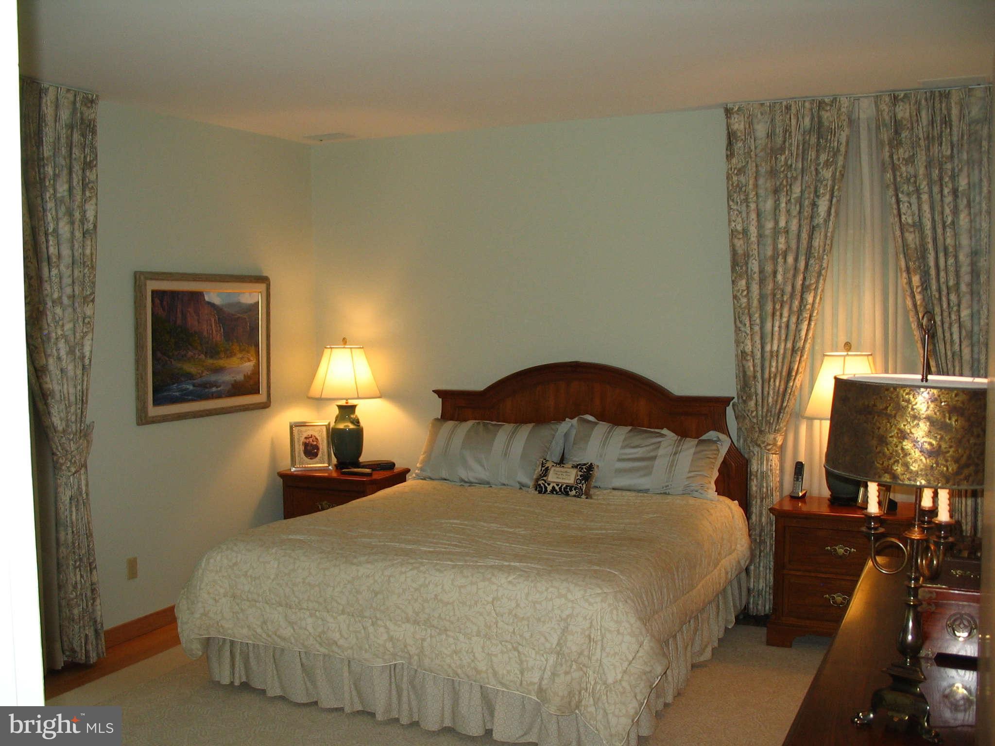 11312 South Shore Road Reston, VA 20190 - Photo 12 of 30 a bedroom with a bed and night stand