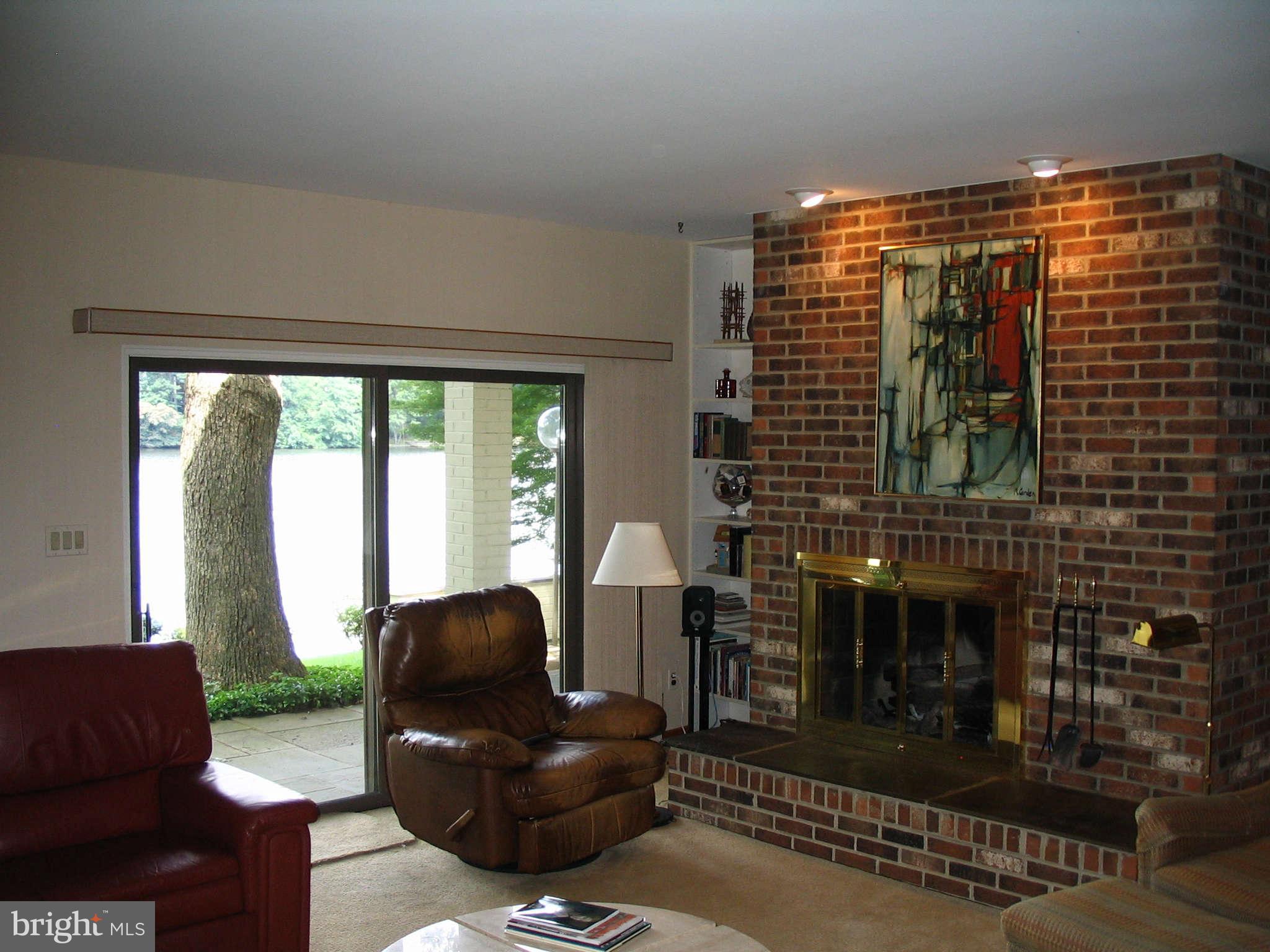 11312 South Shore Road Reston, VA 20190 - Photo 17 of 30 a living room with furniture and a floor to ceiling window