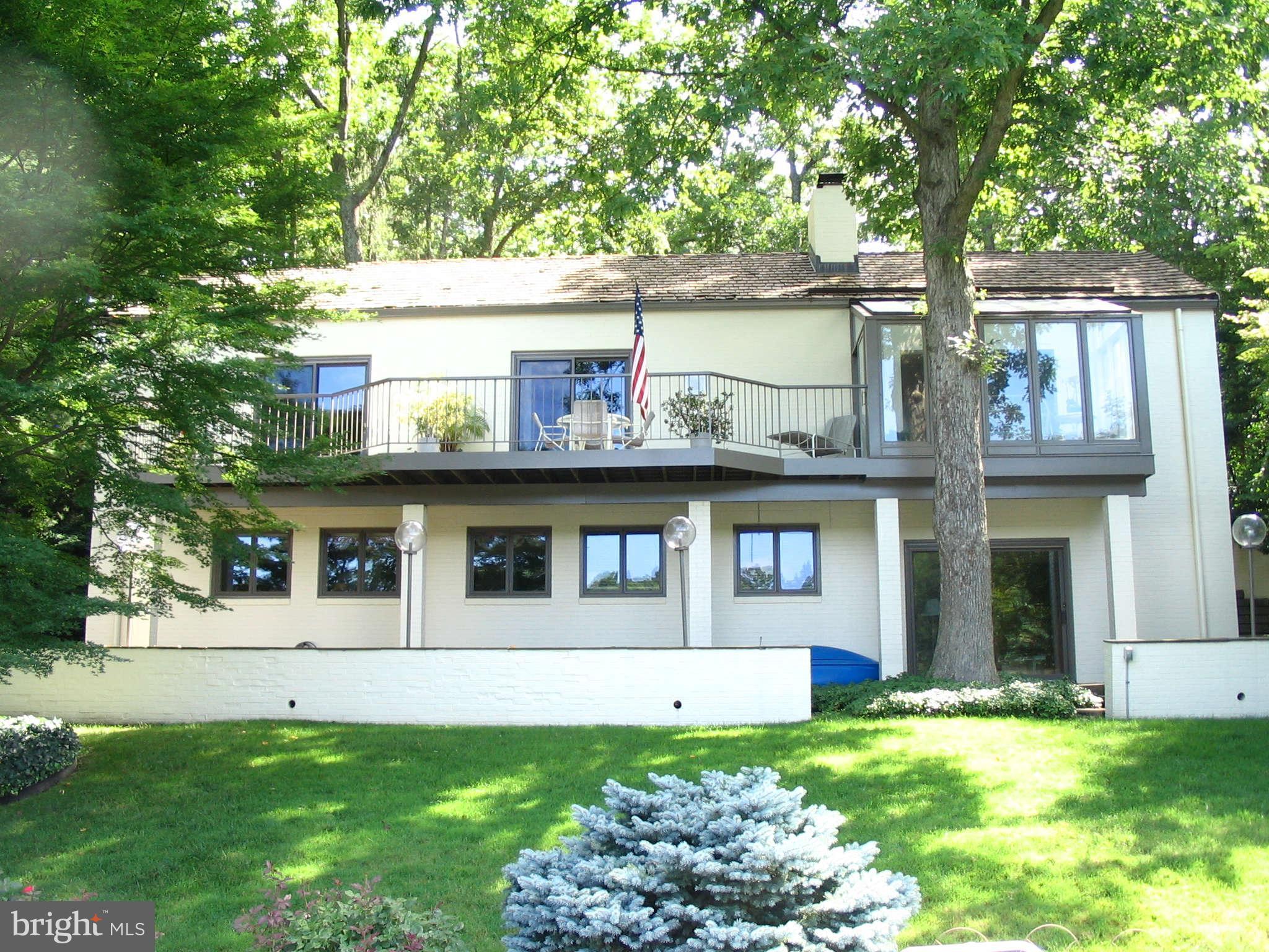 11312 South Shore Road Reston, VA 20190 - Photo 25 of 30 a front view of a house with a garden