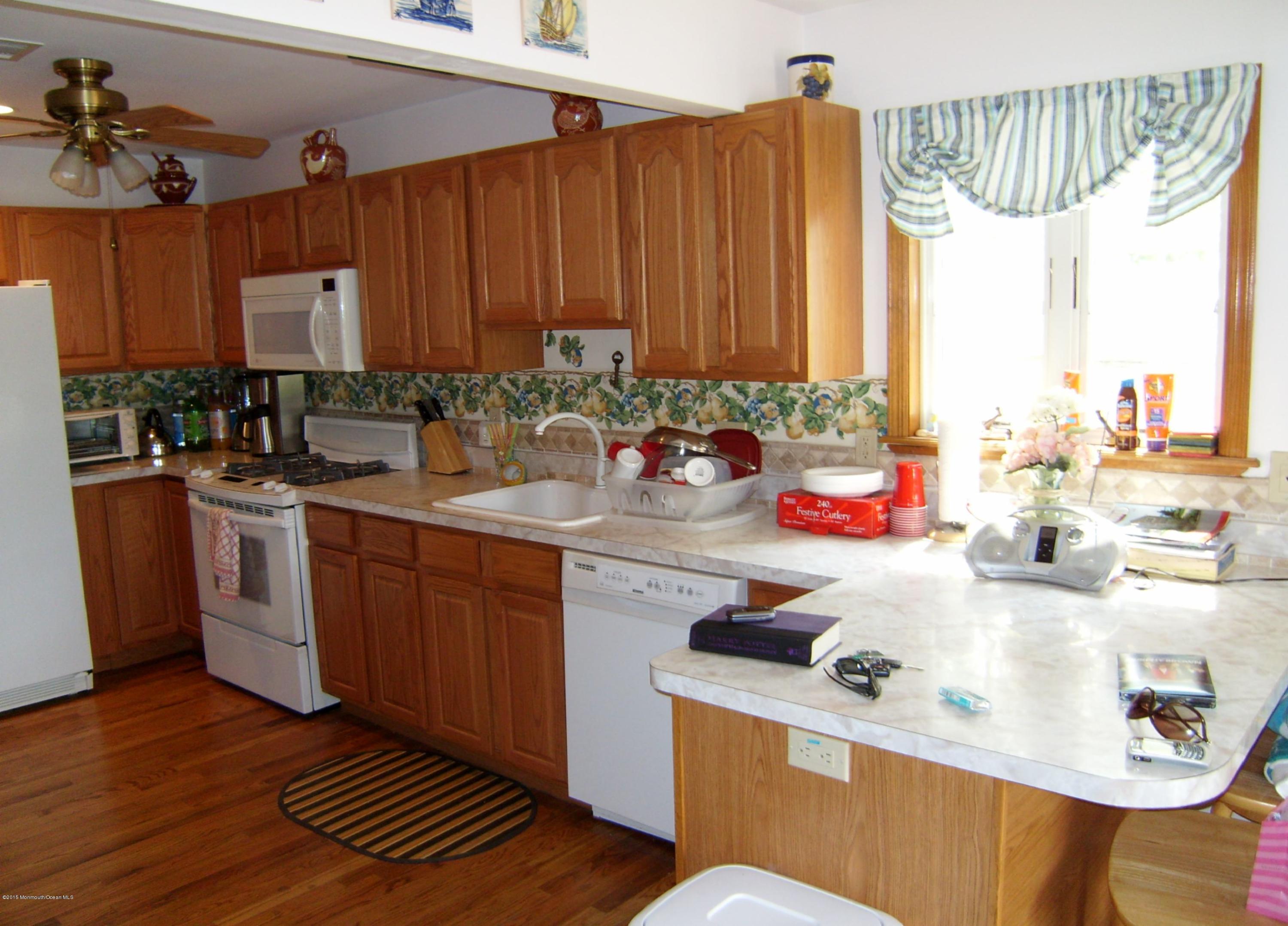 327 New Bedford Road, Unit FRONT Belmar, NJ 07719 - Photo 2 of 4 a kitchen with a sink stove and cabinets