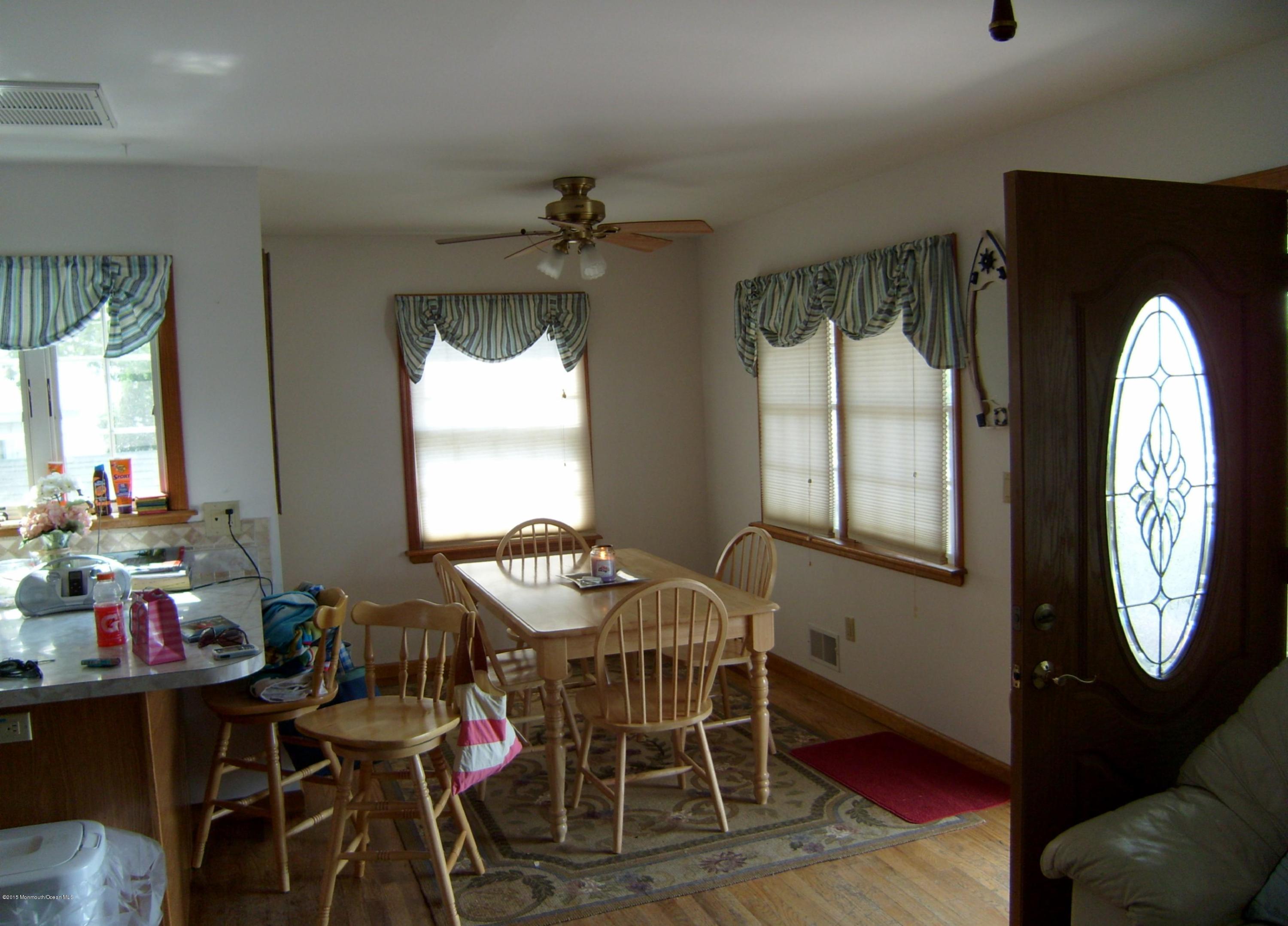327 New Bedford Road, Unit FRONT Belmar, NJ 07719 - Photo 4 of 4 a view of a dining room with furniture window and outside view