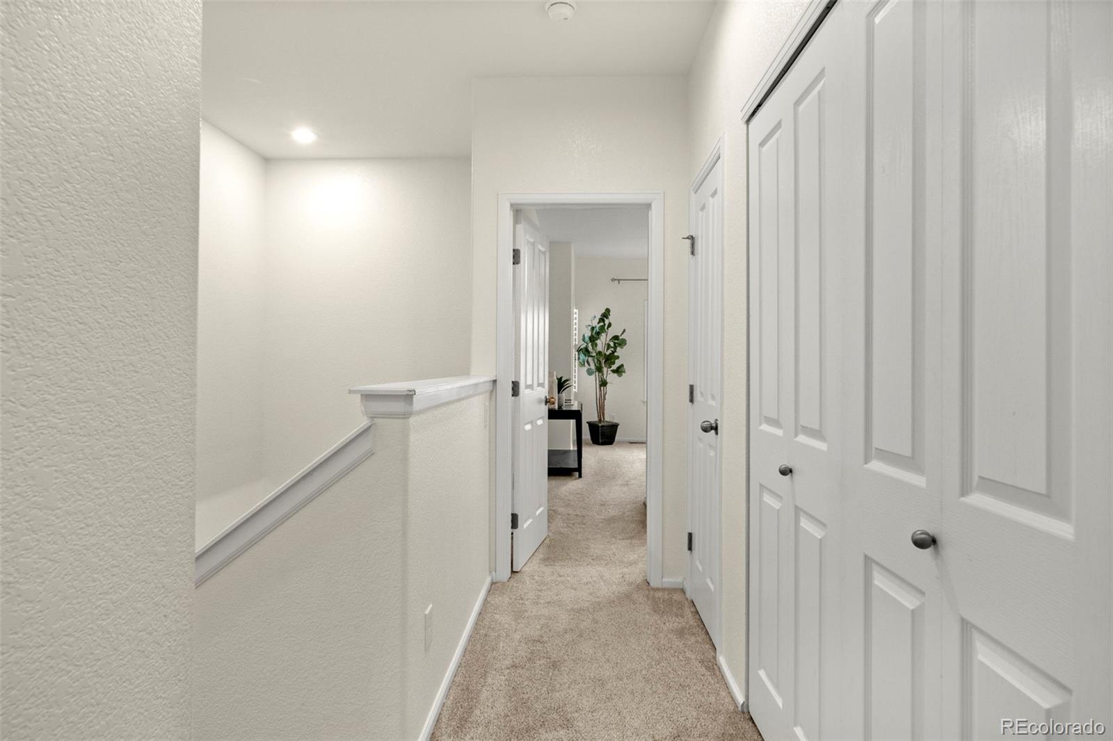 592 Brookhurst Avenue, Unit 26C Highlands Ranch, CO 80129 - Photo 18 of 30 a view of a hallway with white walls and stairs