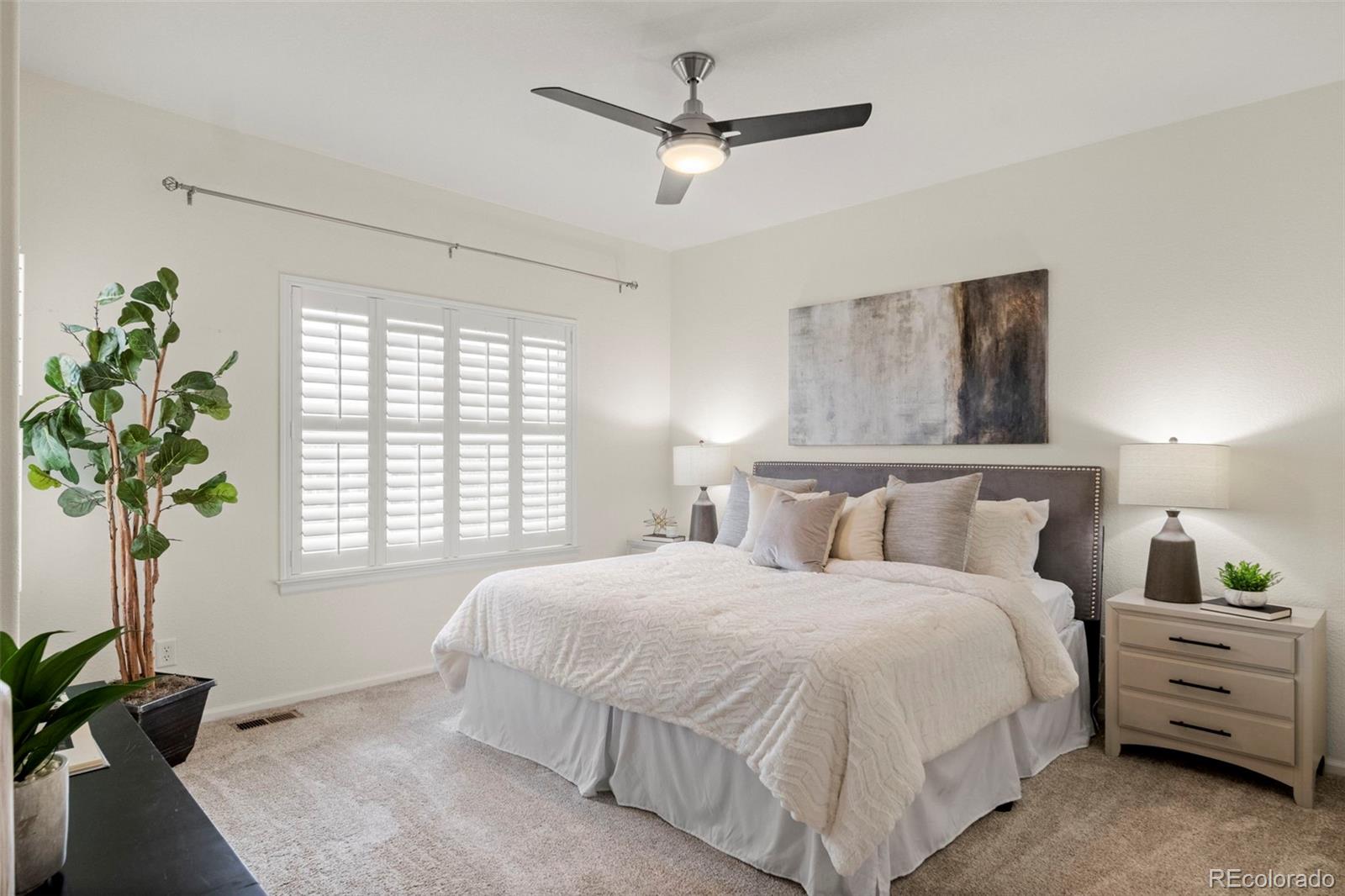 592 Brookhurst Avenue, Unit 26C Highlands Ranch, CO 80129 - Photo 20 of 30 a bedroom with a bed a plant and a window