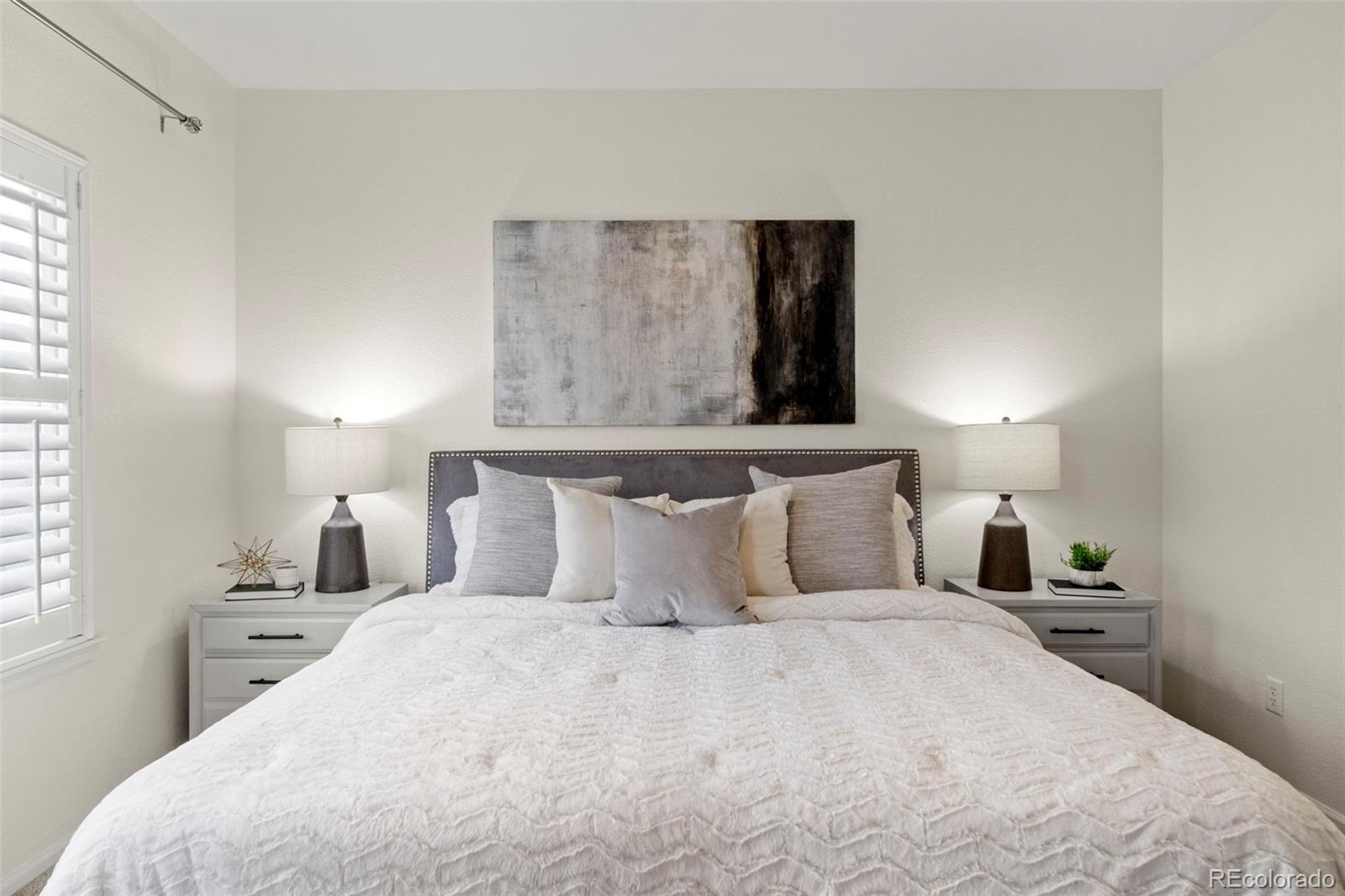 592 Brookhurst Avenue, Unit 26C Highlands Ranch, CO 80129 - Photo 21 of 30 a bedroom with a bed and a night stand