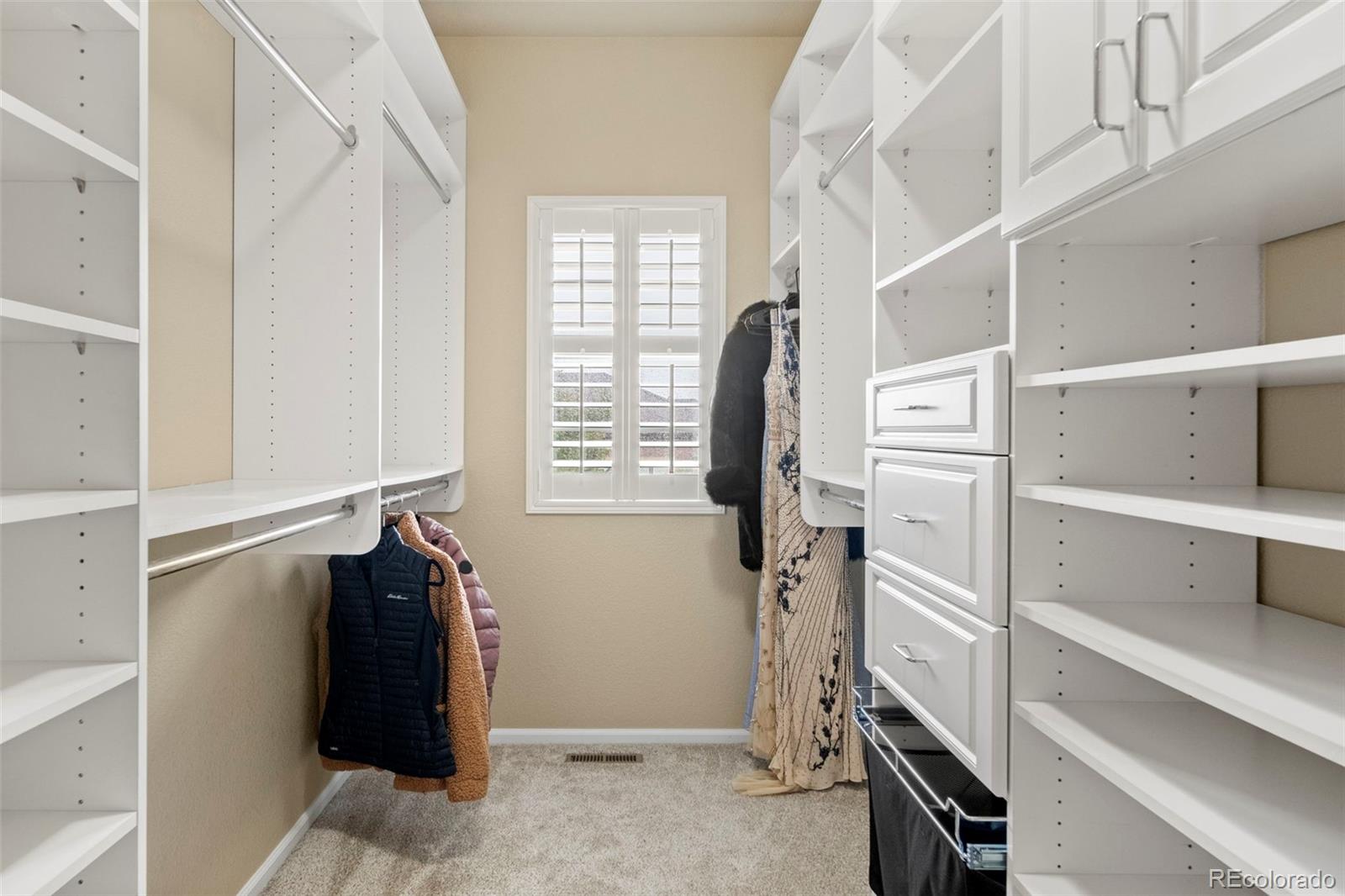 592 Brookhurst Avenue, Unit 26C Highlands Ranch, CO 80129 - Photo 22 of 30 a view of walk in closet with clothes and shoes