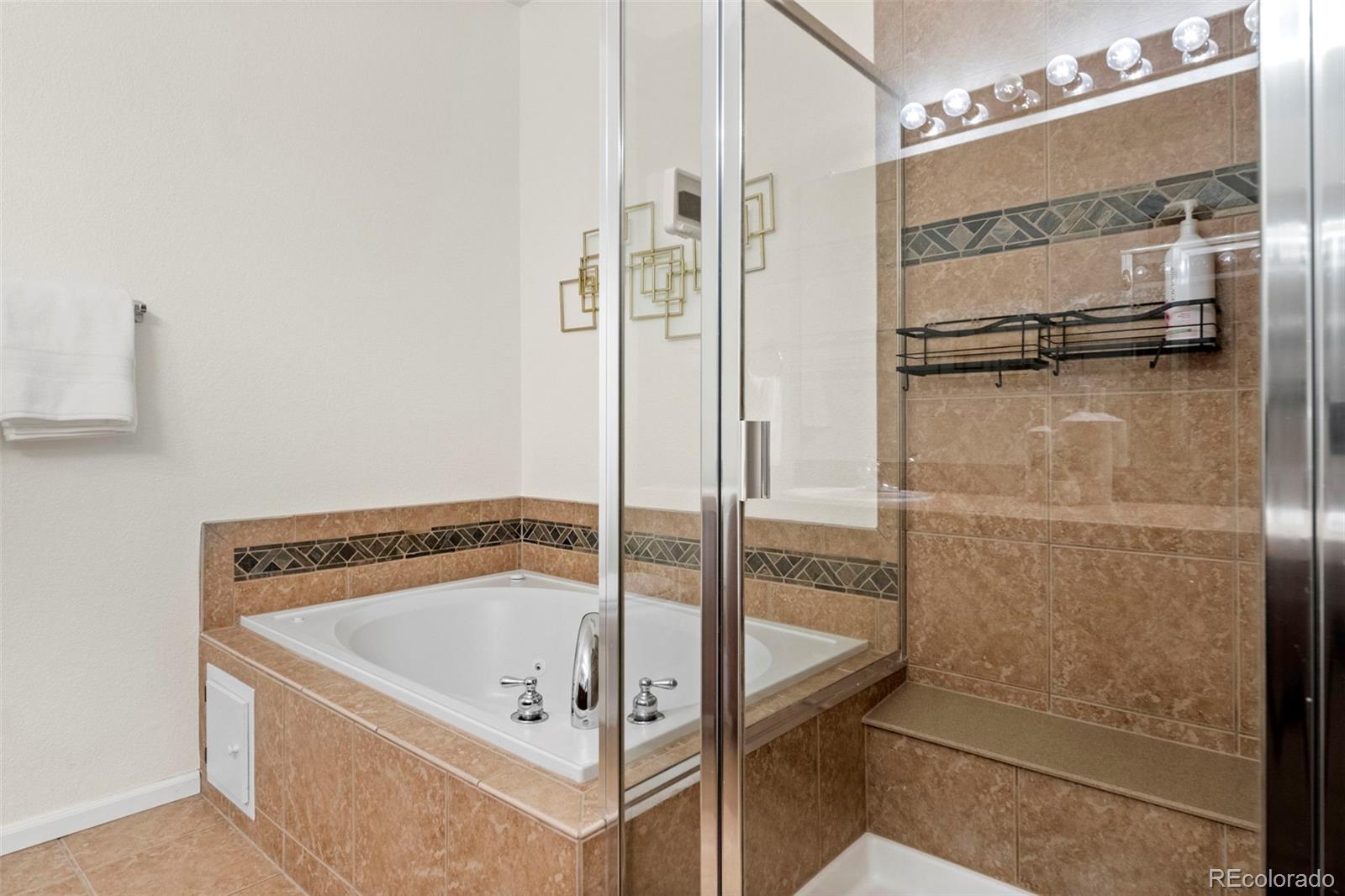 592 Brookhurst Avenue, Unit 26C Highlands Ranch, CO 80129 - Photo 25 of 30 a bathroom with a tub and shower