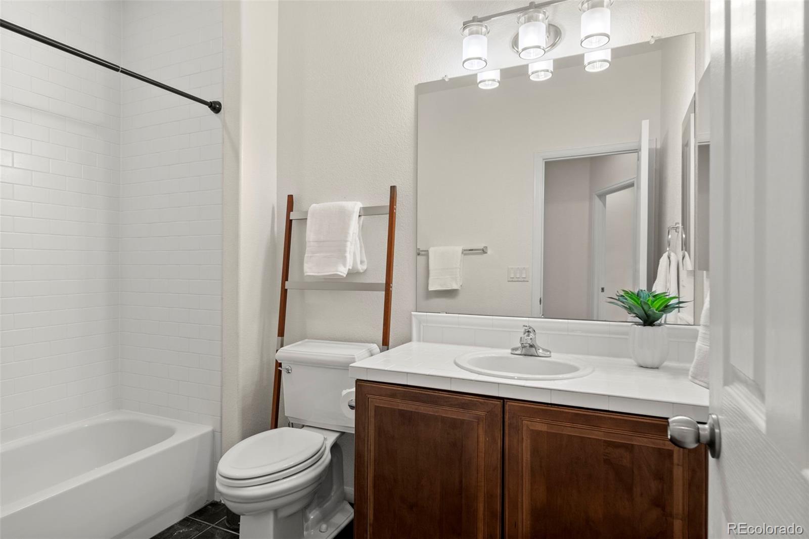 592 Brookhurst Avenue, Unit 26C Highlands Ranch, CO 80129 - Photo 28 of 30 a bathroom with a sink a toilet and shower