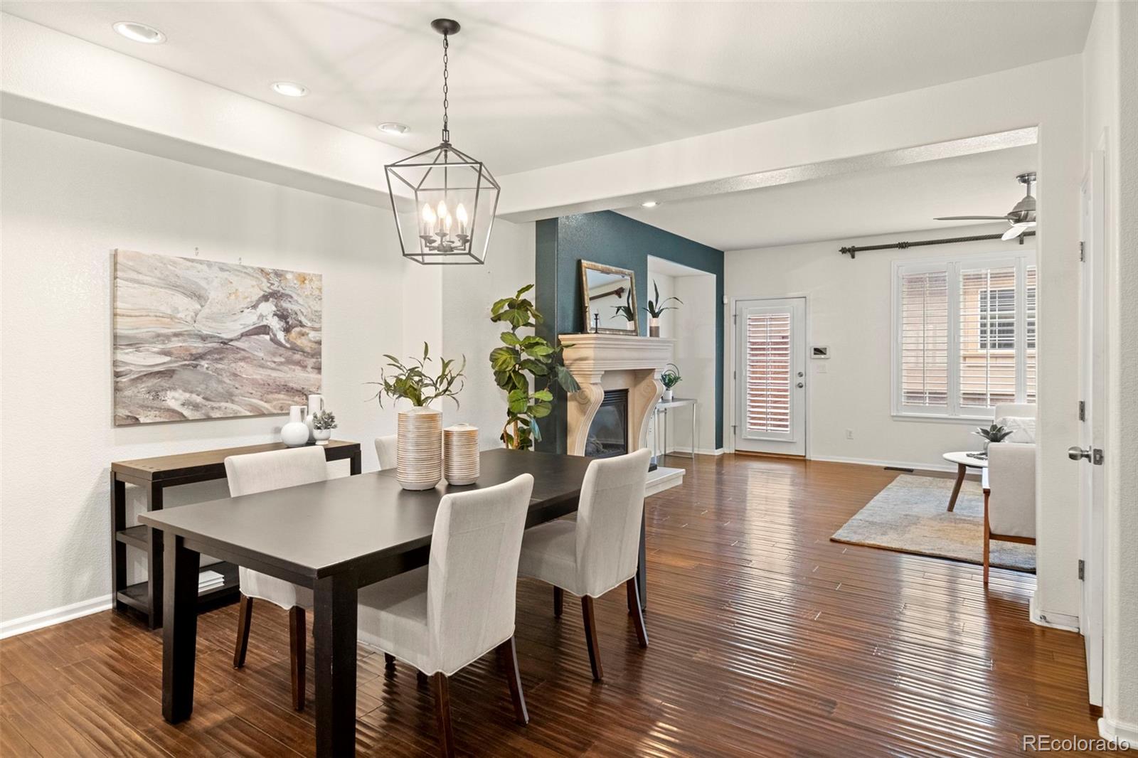 592 Brookhurst Avenue, Unit 26C Highlands Ranch, CO 80129 - Photo 7 of 30 a view of a dining room with furniture wooden floor and a chandelier