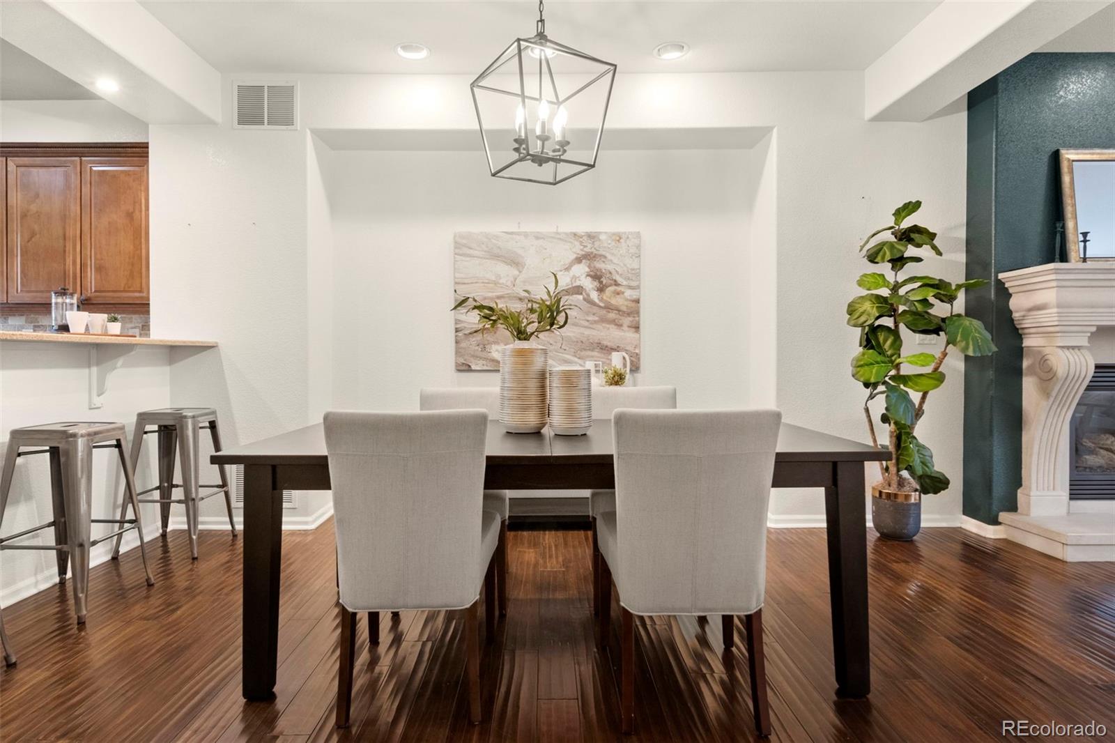 592 Brookhurst Avenue, Unit 26C Highlands Ranch, CO 80129 - Photo 8 of 30 a view of a dining room with furniture a chandelier and wooden floor