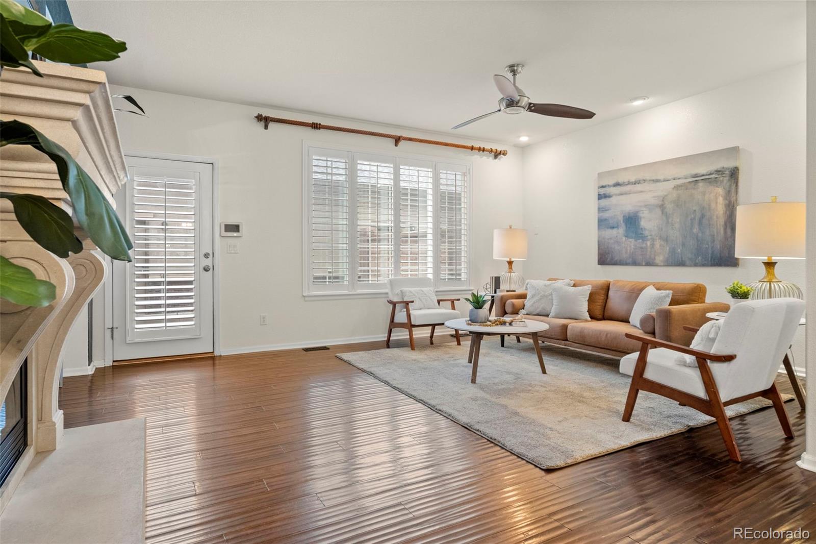 592 Brookhurst Avenue, Unit 26C Highlands Ranch, CO 80129 - Photo 9 of 30 a living room with furniture and a wooden floor
