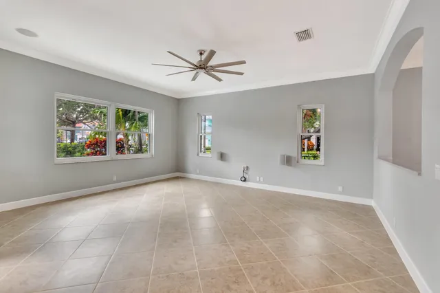 a view of a livingroom with a ceiling fan and window