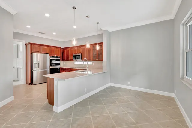 a view of kitchen with stainless steel appliances refrigerator sink and microwave