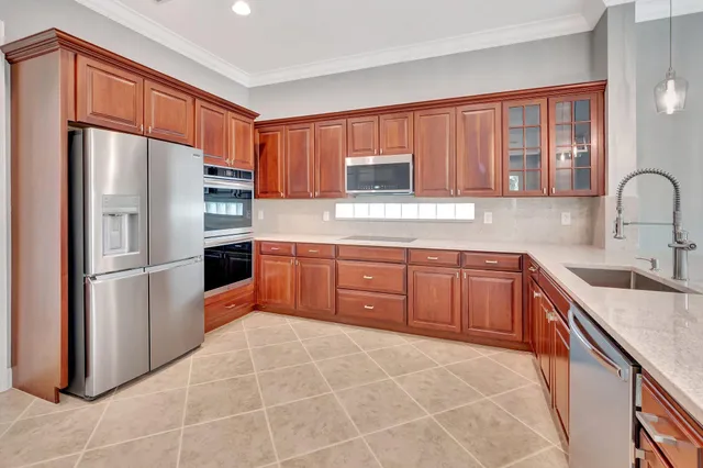a kitchen with stainless steel appliances granite countertop a refrigerator sink and cabinets