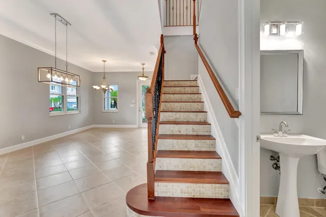 a view of an entryway with wooden floor and staircase