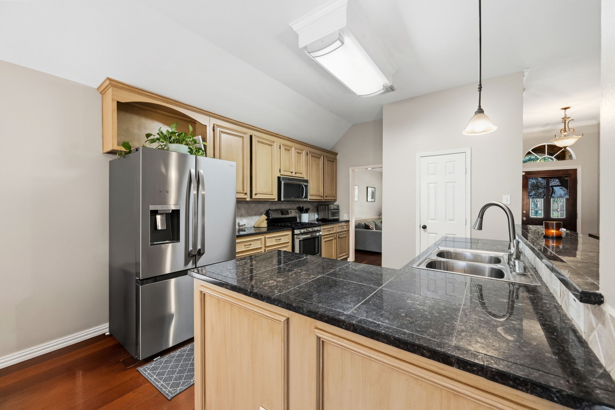 7514 Tumbling Road Humble, TX 77346 - Photo 11 of 28 a kitchen with stainless steel appliances granite countertop a refrigerator a sink and a stove