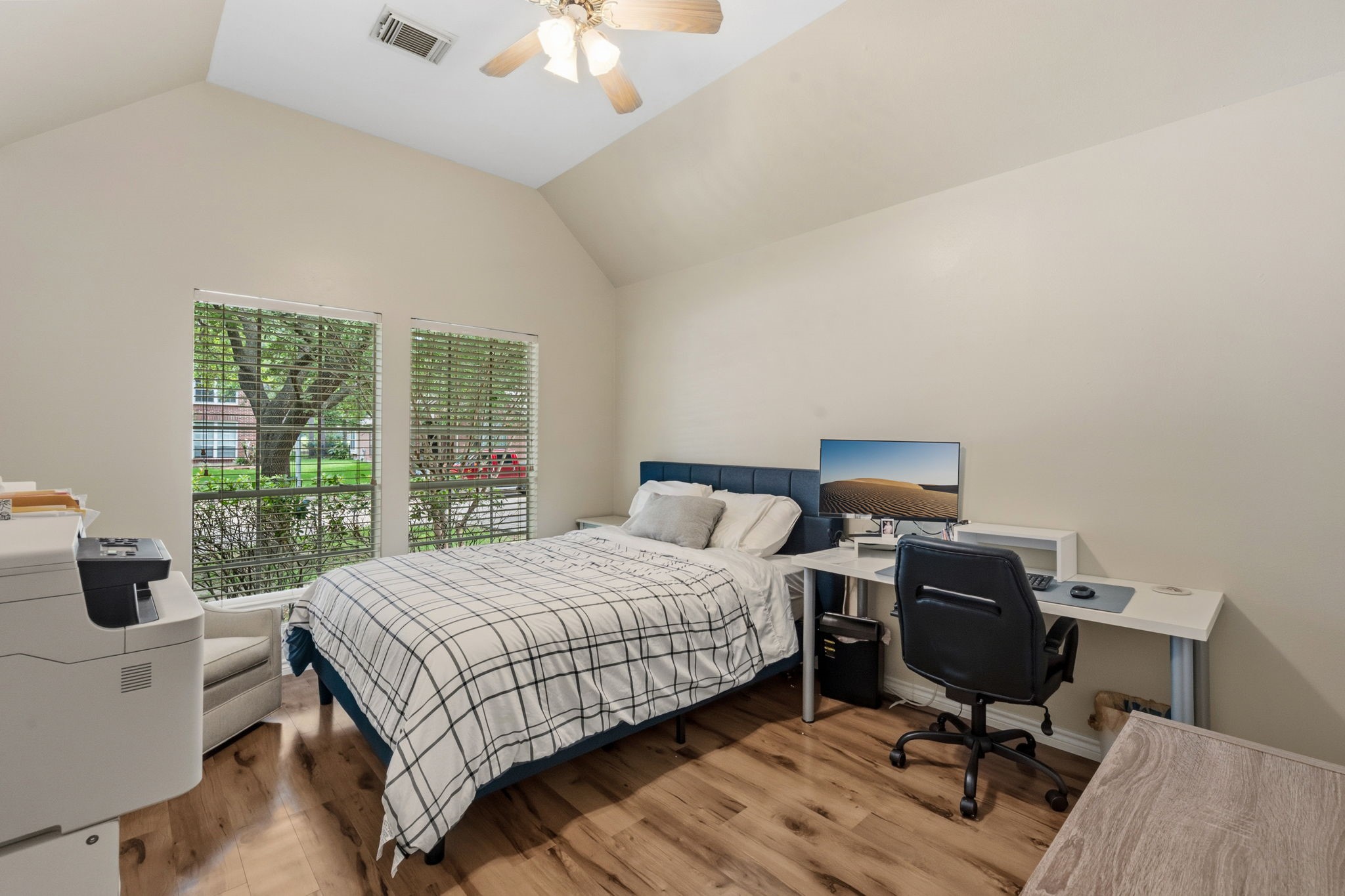 7514 Tumbling Road Humble, TX 77346 - Photo 19 of 28 a bedroom with a bed a desk and chair with wooden floor
