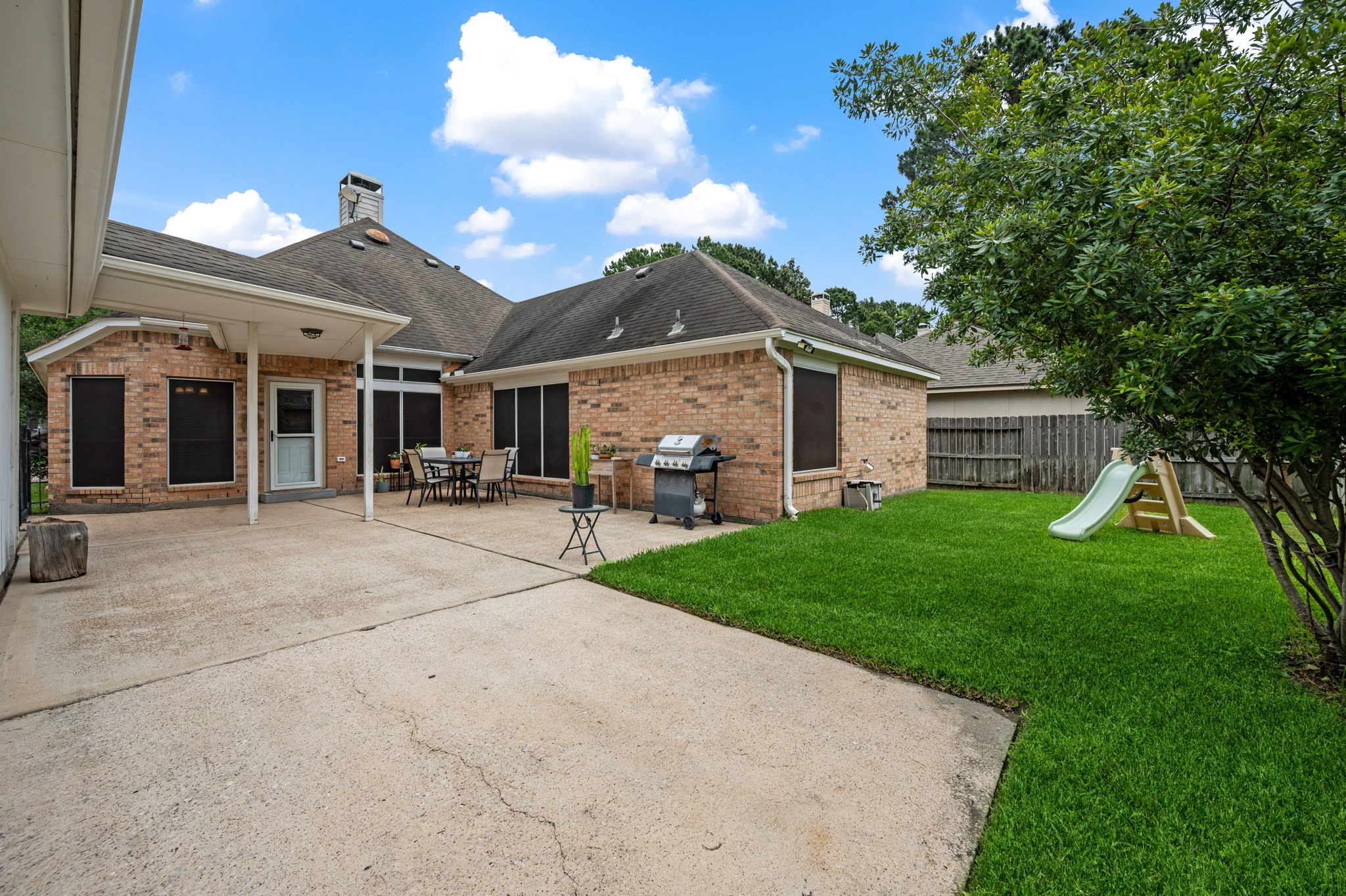 7514 Tumbling Road Humble, TX 77346 - Photo 25 of 28 a front view of a house with a garden and plants