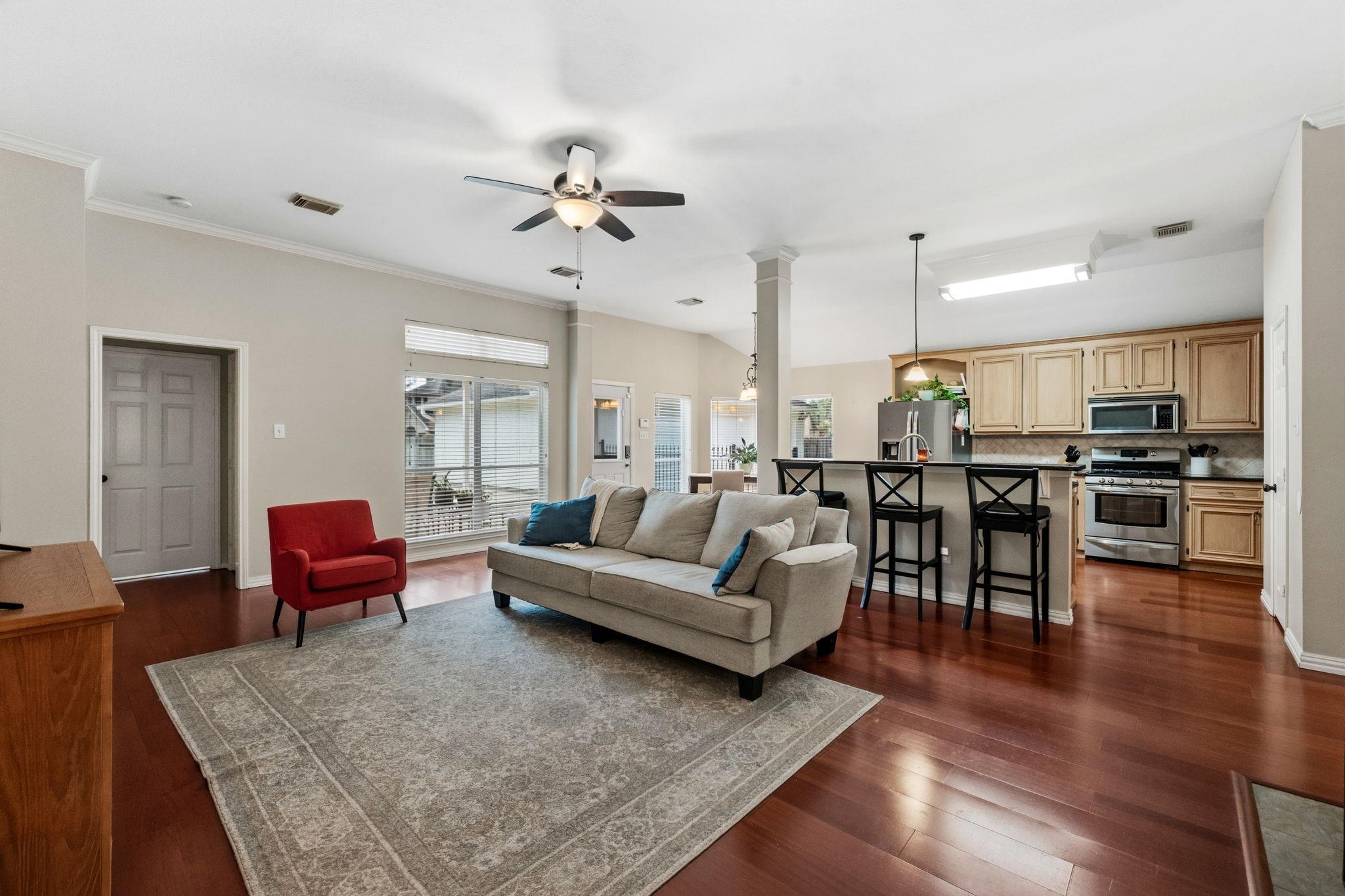 7514 Tumbling Road Humble, TX 77346 - Photo 6 of 28 a living room with furniture kitchen view and a wooden floor