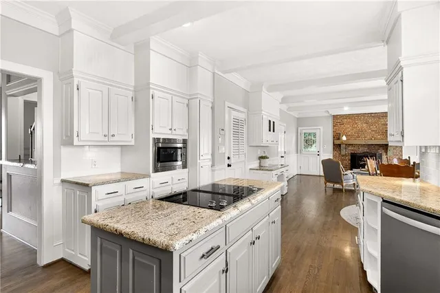 a kitchen with granite countertop a sink stove and cabinets