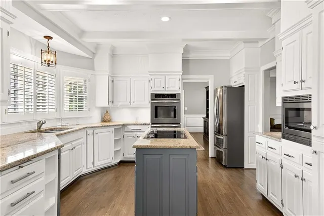 a kitchen with granite countertop a refrigerator stove top oven and sink