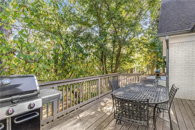 a view of backyard with seating and trees