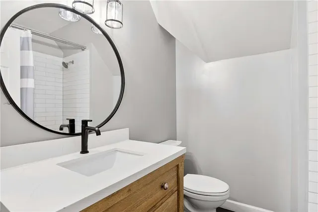 a bathroom with a sink a mirror and a toilet