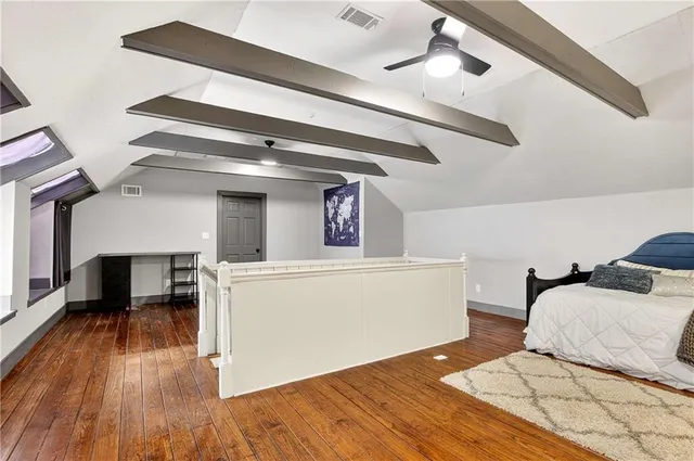 a bedroom with a bed and a chair