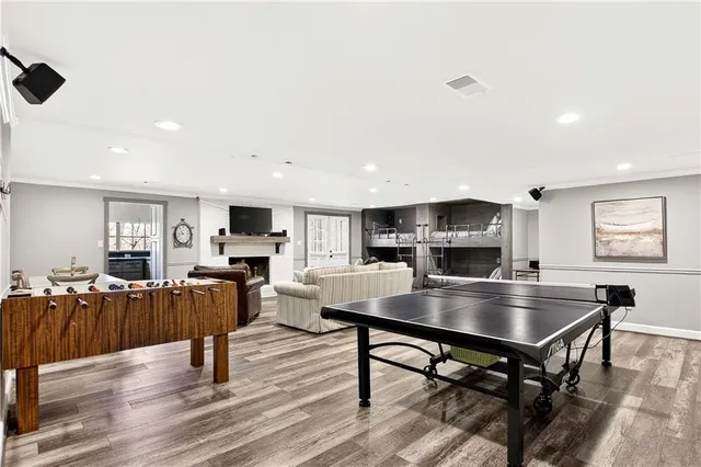 a living room with stainless steel appliances furniture and a flat screen tv