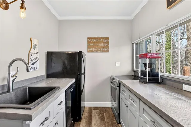 a kitchen with stainless steel appliances a sink stove and refrigerator