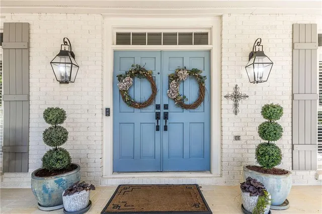a front view of a house with potted plant