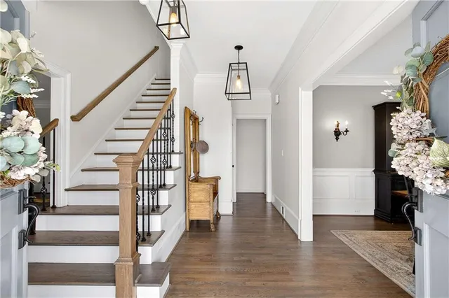a view of entryway and hall with wooden floor