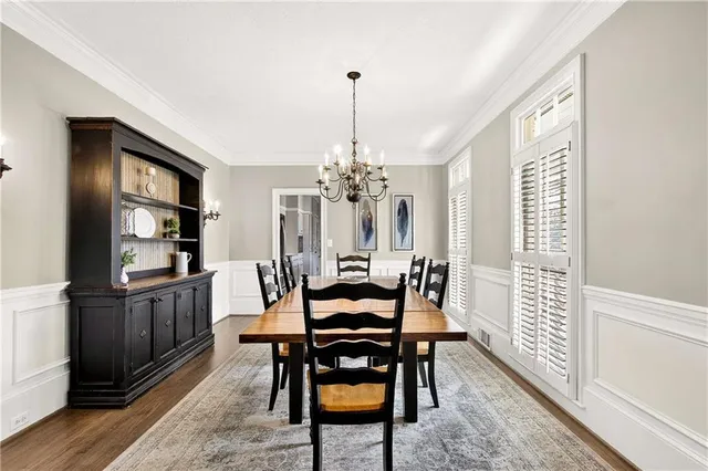 a dining room with furniture window and wooden floor