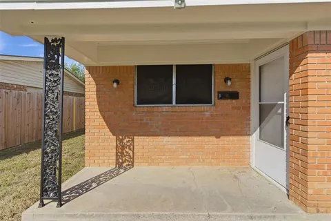 an empty room with wooden floor and a ceiling fan