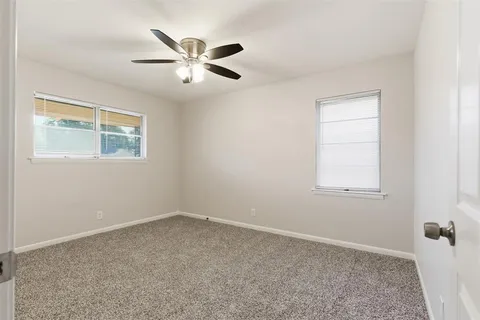 a view of a livingroom with a ceiling fan and window