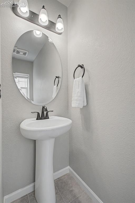 4467 Hessite Loop Colorado Springs, CO 80938 - Photo 15 of 37 a bathroom with a sink a mirror and vanity